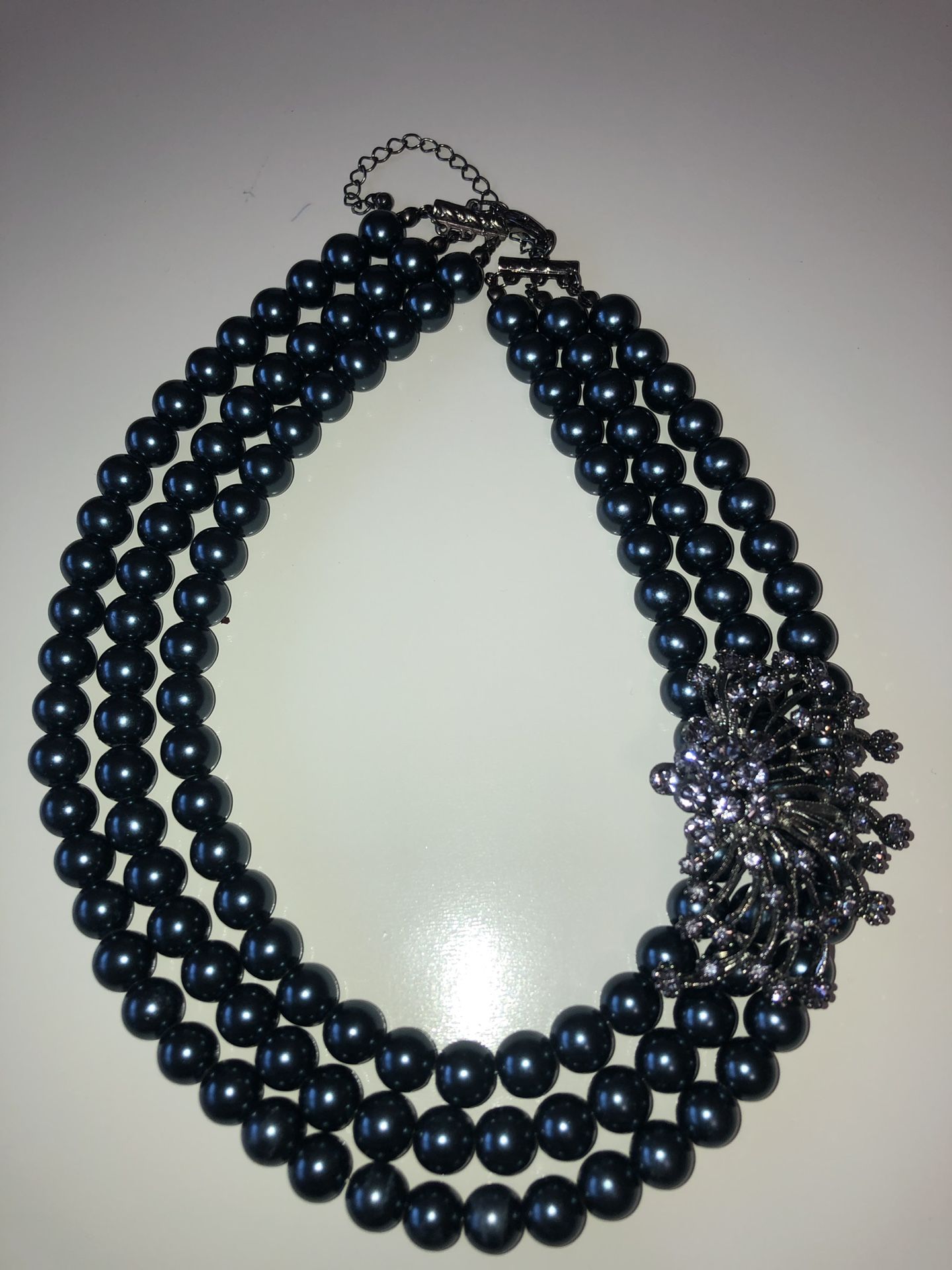 Gunmetal grey pearlesque triple strand necklace with rhinestone accent