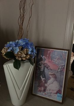 Glass vase with flowers and picture