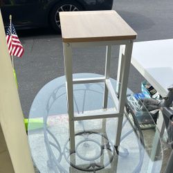backless industrial-style bar stool with a natural wood-look seat and a white metal frame