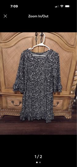 Black and grey dress with ruffle details on sleeve and hemline. By Addressing Women, size large.