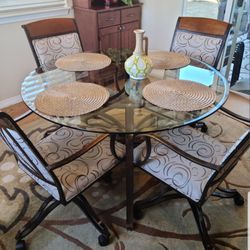4 Swivel Iron Upholstered Chairs & Glass Top Table 