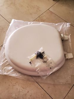 New white padded toilet seat still in plastic