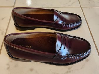 G.H. Bass & Co. Weejuns penny loafers feature a classic burgundy polished leather finish