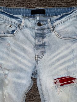 Light Wash Distressed Jeans with Red Patch