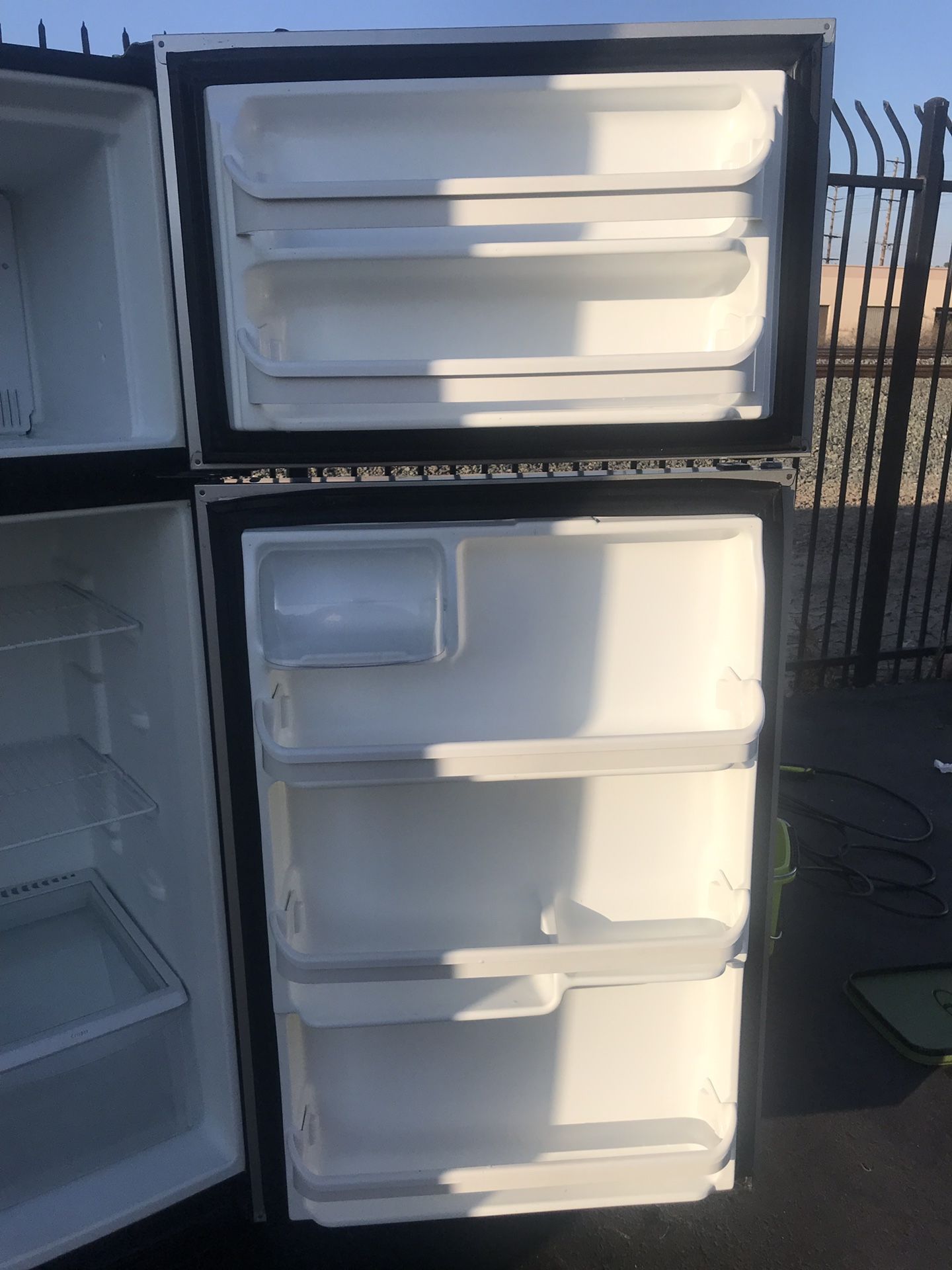 Stainless steel and black apartment full size Frigidaire refrigerator