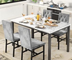 A dining table and four chairs