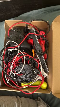 Box full of controllers and cables