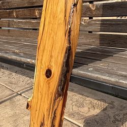 Live edge wood slab with a glossy finish.