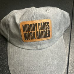 Gray Dad Hat With A Leather Patch “Nobody Cares Work Harder” Engraving 