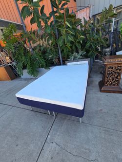 Medium-profile foam mattress with a white top cover and navy blue sides. Full size.