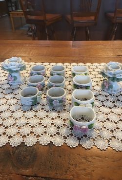 Set of 10 porcelain Vintage napkin ring holders. 6 smaller and 4 a little larger. Two porcelain candle holders.