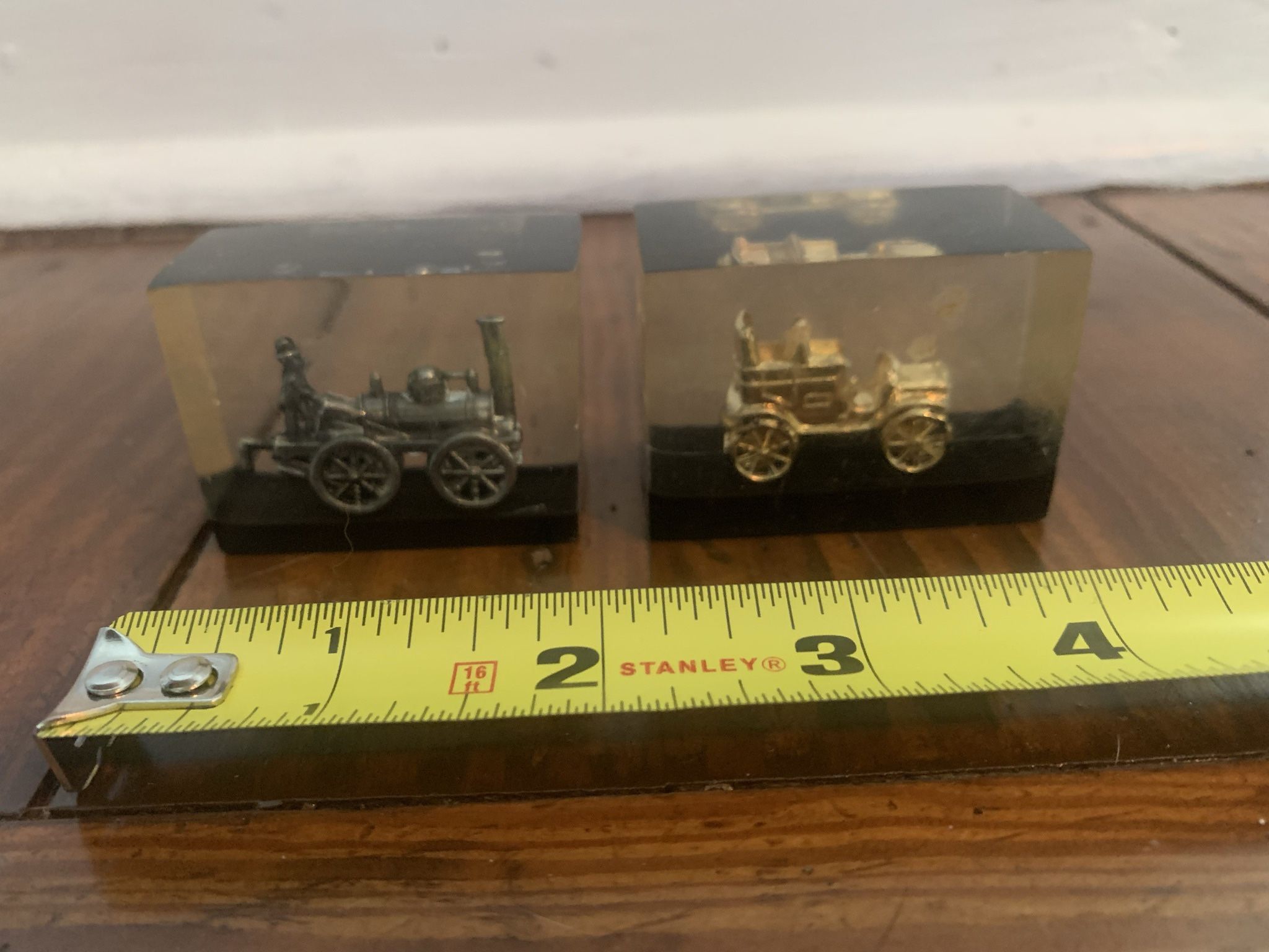 Two vintage Lucite acrylic paperweight suspended metal miniature train conductor