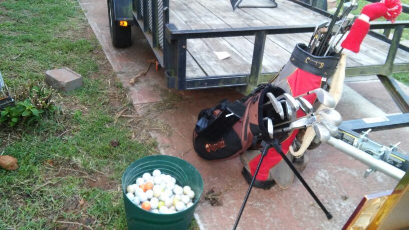 His and Her golf clubs and a lot of balls