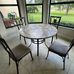 Round table with marble top with four chairs, and two stool chairs