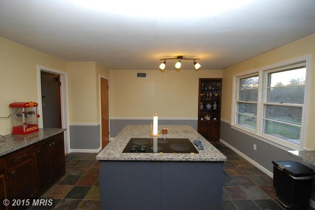 Kitchen island with inch and a half thick Granite as well as a Frigidaire glass top stove