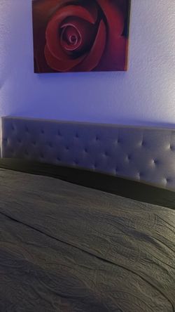 Gray upholstered king size headboard in very good condition padded