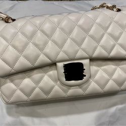 Quilted shoulder purse and gold hardware.