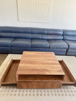 Rotating coffee table with drawer storage CB2