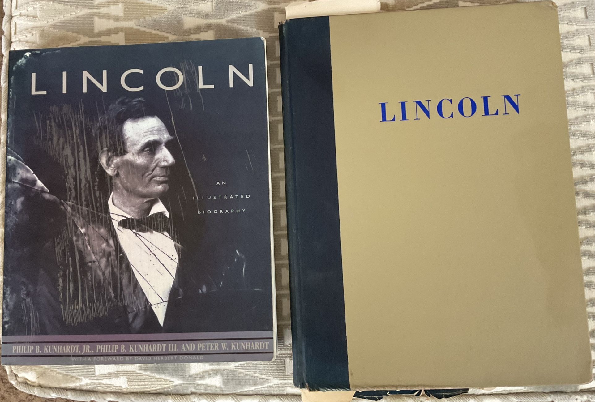 A set of two Lincoln books, one an illustrated biography and the other a picture story of his life.