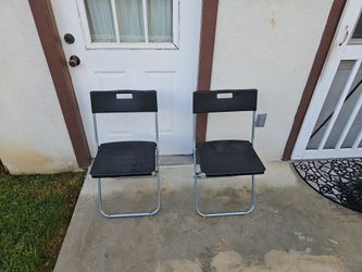2 black plastic chairs