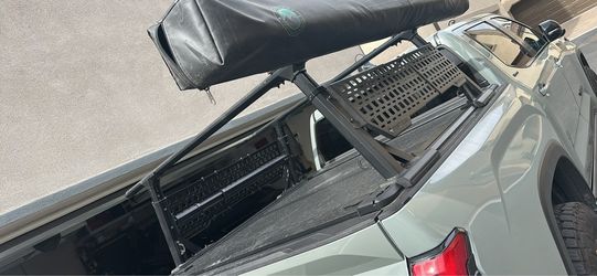 Syneticusa retractable tonneau and ladder rack with molle panels