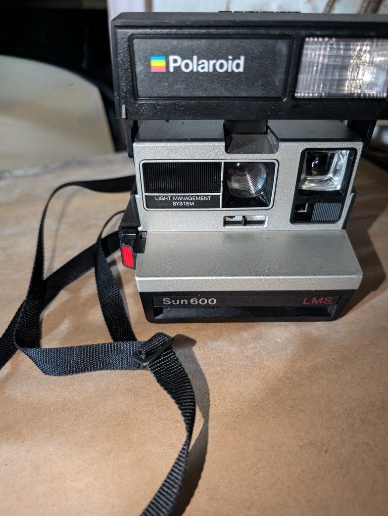 Polaroid Sun 600 LMS Camera With A Strap. Still Has Film In It, But Its Old, They Still Make It