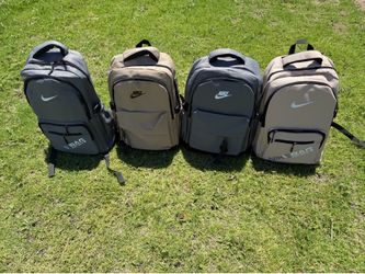 Grey and tan Nike backpacks