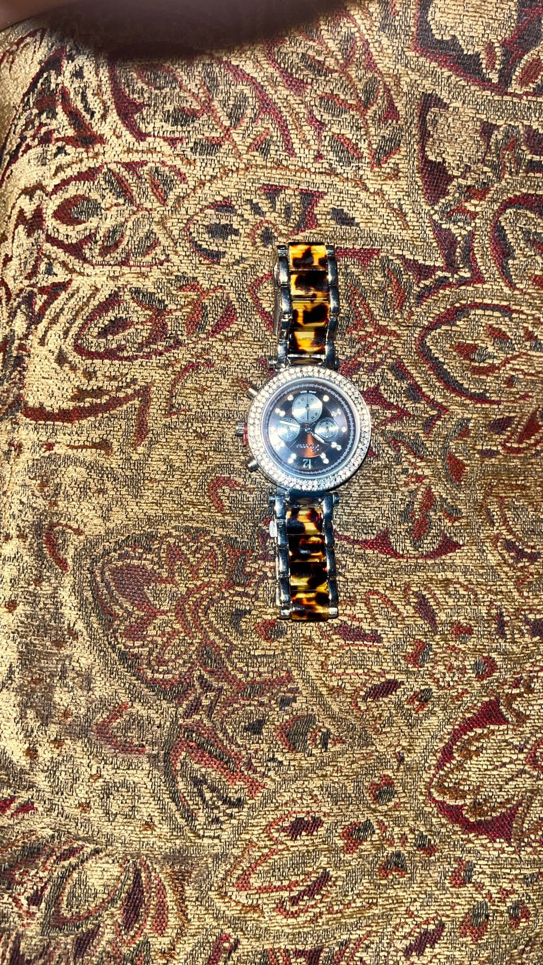tortoise shell band geneva watch.