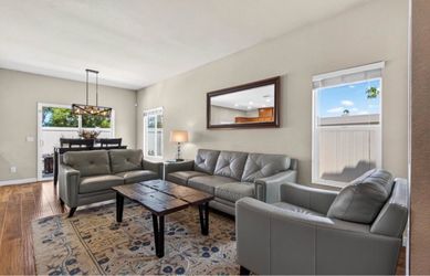 Leather Sofa, love seat and chair. Comes with wood coffee table and rug