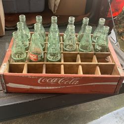 Coca Cola crate and 15 Coke bottles