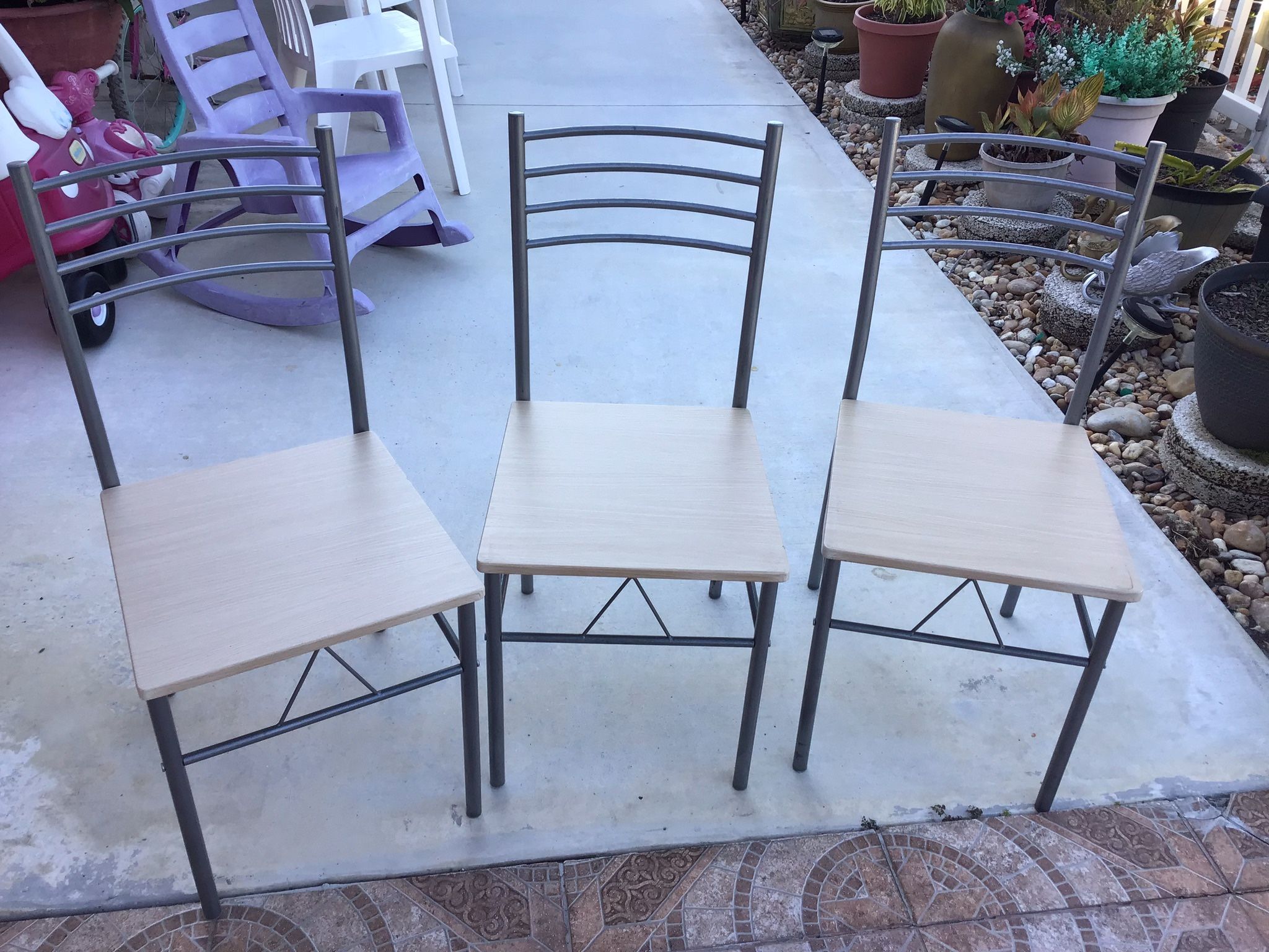 Three identical chairs in good condition, made of metal and wood.