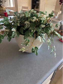 Plastic planter with artificial plant