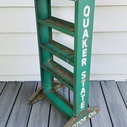 Vintage Quaker State Motor Oil standing display shelf  35 1/2” tall. 16 1/2” length.  4 1/2” wide body. 14” wide on the legs bottom area . 