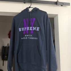 Supreme NY Hooded Sweatshirt in navy with purple chenille appliqué from the Fall/Winter 2019 collection. 