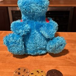 Sesame Street talking cooking monster with three cookies