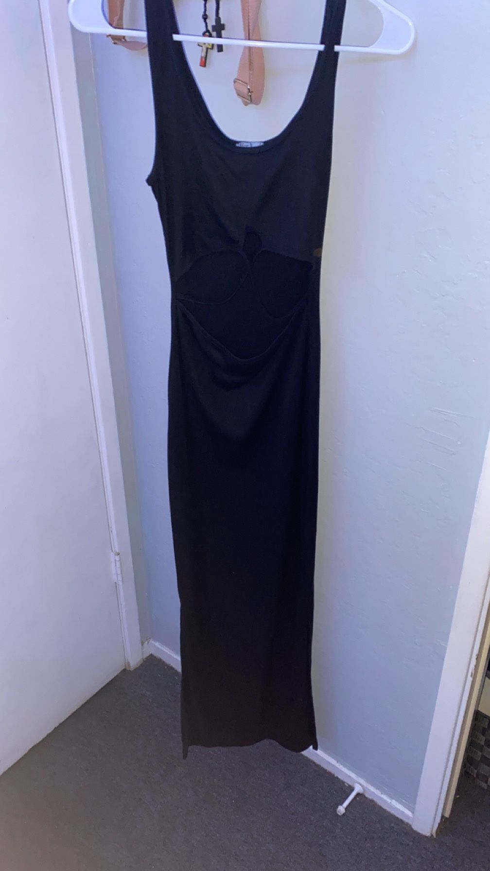 black sundress, open on stomach area & has slits at the bottom