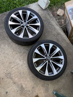 Genuine Nissan 19-inch alloy wheels with a two-tone silver and charcoal finish. These wheels are mounted with Goodyear Eagle F1 Asymmetric All-Season 