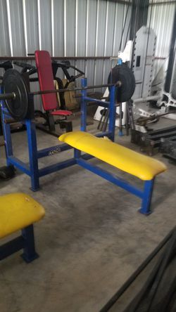 Commercial gym equipment bench press bar and 45lb steel plates