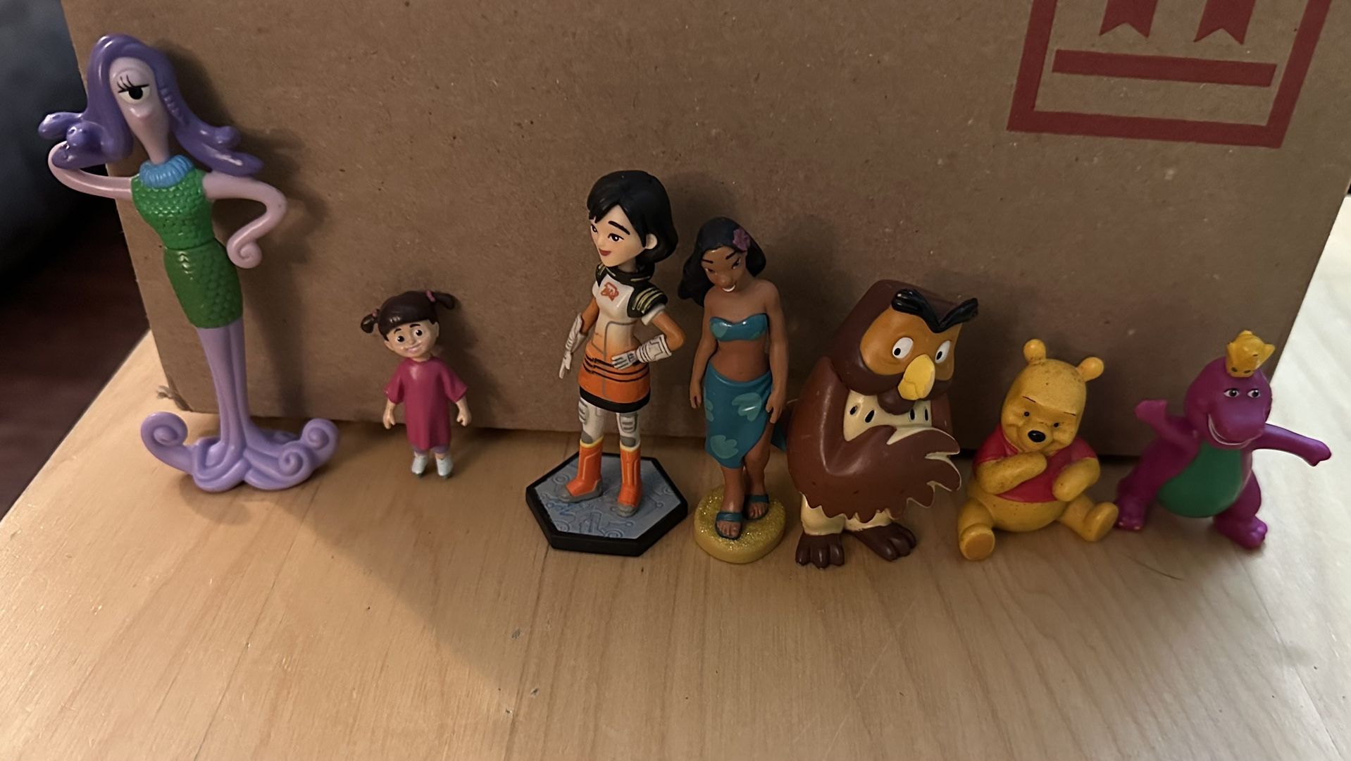 Disney toy figures and a Barney figure