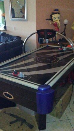 Air hockey table for a game room keeps up scores it talks when you hit the score
