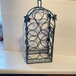 Metal Wine Rack. Holes seven bottles.