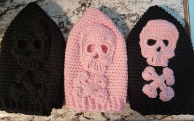 Hand crocheted skull hats in pink and black.   $10 each