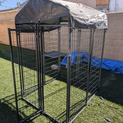 Sturdy metal dog kennel with a protective cover