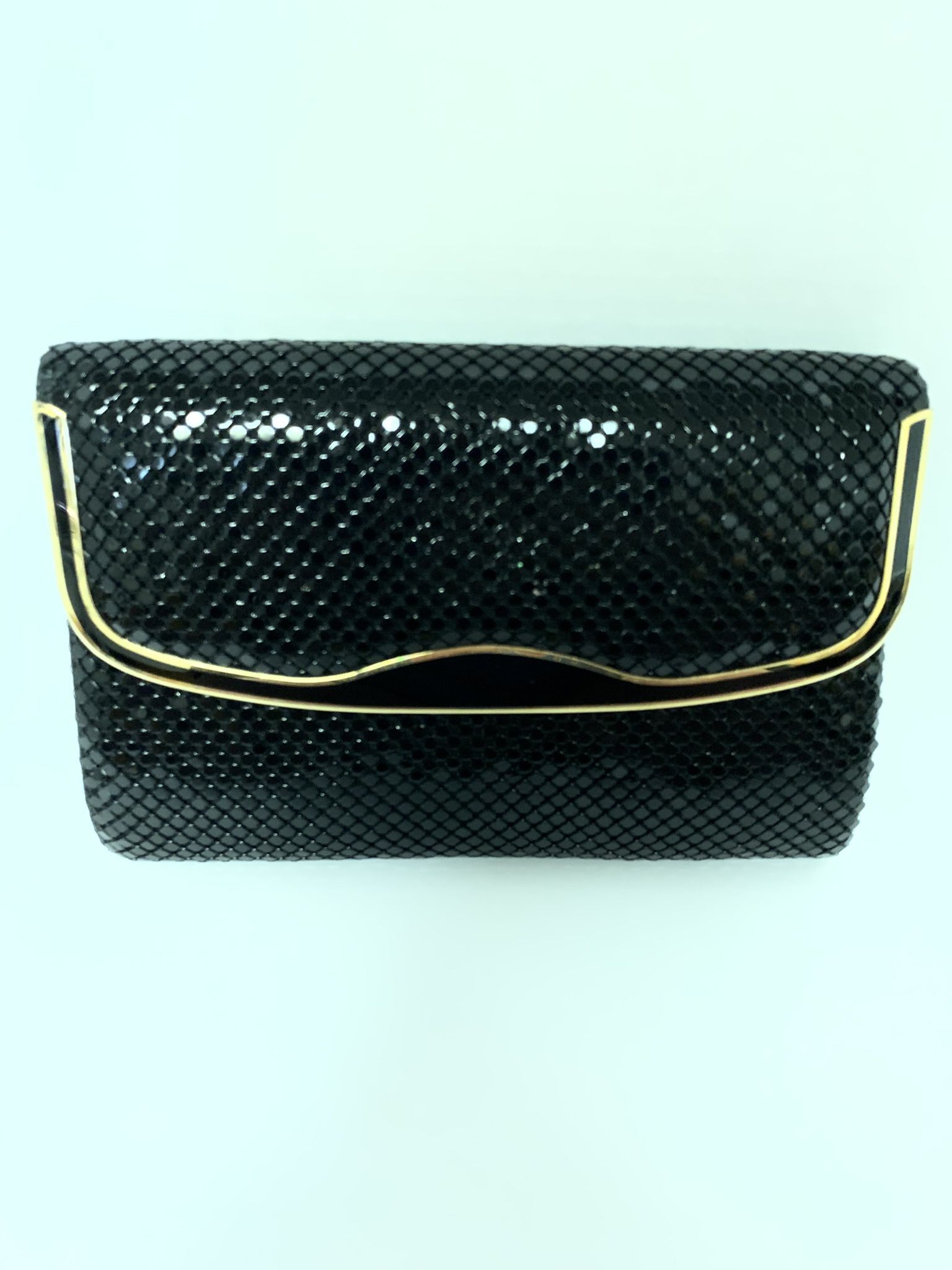 Clutch Purse black for evening wear with gold trim. Great for wedding. Has a long chain if you want to wear as shoulder purse. Great for we