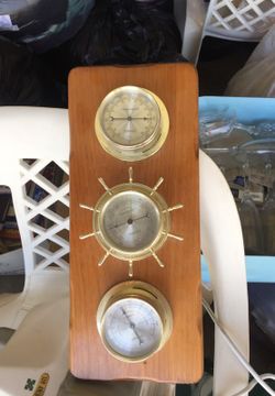 Thermometer, barometer, and humidity set on wood base