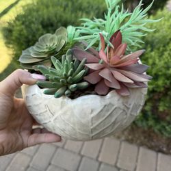 Artificial succulents and cacti in planter