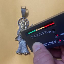 The Santa Muerte made of silver plated with 14-carat gold and diamonds, the regular price is 485 I’m only asking for 280, firm price 