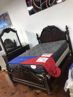 Cherry brown bedroom set includes dresser mirror and queen bed frame