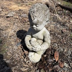 Child holding bird cement statue