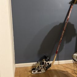 Size 6.5 men’s ice skates and hockey stick